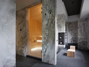A modern spa interior with marble walls and wooden accents.