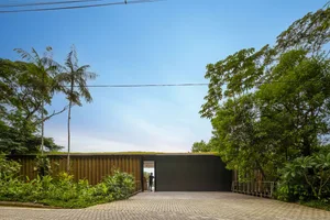 Modern residence extension featuring wooden cladding and a verdant rooftop garden.