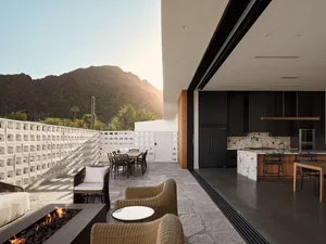 Contemporary residential kitchen with concrete and glass materials and marble countertops.