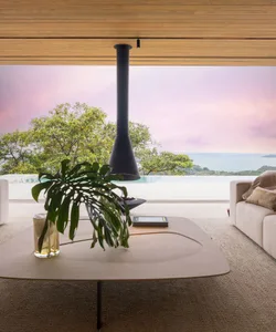 Modern living room with large glass windows and a wood floor.