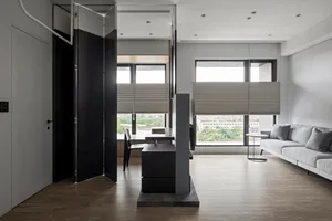 A modern living room featuring glass, wood, and fabric materials with a minimalist design.