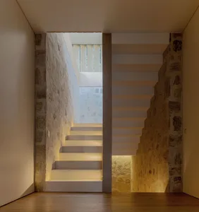 Concrete stairs with built-in lighting and stone walls
