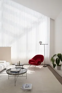 A modern interior design featuring a glass window with vertical blinds.