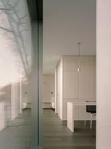 A modern office space featuring a combination of wood, glass, and metal materials.