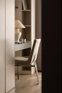 A minimalist home office with white furniture and a beige lamp on a white desk.