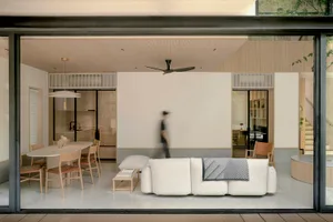 A minimalist living room with terrazzo flooring.