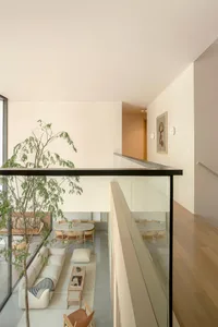 A minimalist living space showcasing a terrazzo floor and furniture.