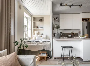A minimalist apartment with neutral tones and modern furniture.