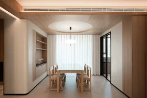 A modern dining room featuring wood and glass materials.