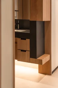 Modern interior design featuring wooden cabinets with black accents.