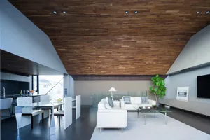 A modern living room with a wooden ceiling, white sofas, and a glass coffee table.