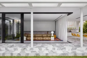 Modern minimalist living room with concrete, leather, and marble elements
