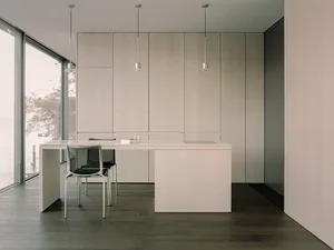 A minimalist office space featuring concrete walls and floors.