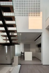 Modern minimalist interior design with open-plan layout, featuring sleek, contemporary materials and clean lines.