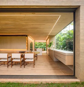 Modern dining room with concrete ceiling and wooden floor and chairs