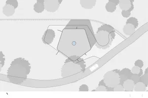 A minimalist, contemporary building with geometric shapes on a site plan.