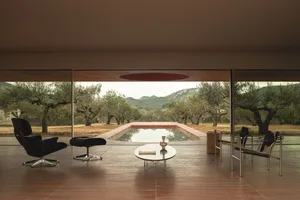 A modern interior design featuring wooden floors, glass walls, and a concrete swimming pool.