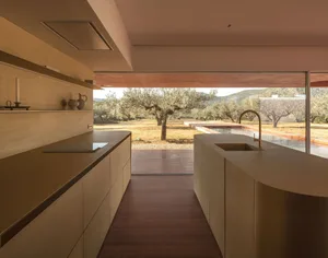 A modern residential kitchen featuring natural wood cabinets and countertops.