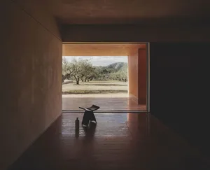 An interior residential space featuring hardwood flooring and a minimalist design.