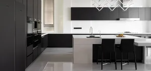 Modern black kitchen featuring a sleek white countertop and minimalist design elements.