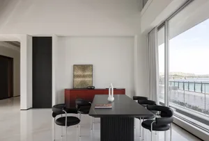 A modern residential interior with metal, glass, and ceramic materials.