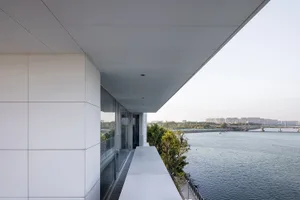 Modern house with glass terrace overlooking the water.