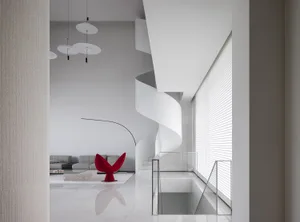 A minimalist interior design featuring a white marble staircase.