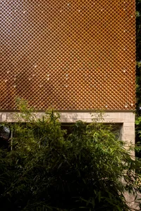 A diamond-patterned wooden facade of a building, featuring a lattice-like design.