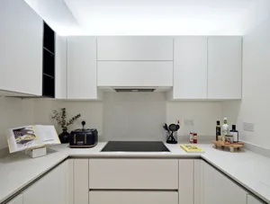 Modern, white kitchen cabinets with a minimalist design.