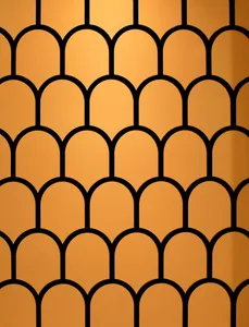 A pattern of overlapping metal arches forming a mesh-like design against an orange background.