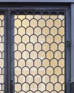 Black metal window with metallic arch patterns
