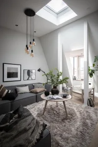 A minimalist living room with concrete, wood, and metal materials.