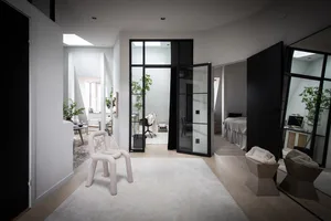 A minimalist residential interior with mixed materials and a modern, open-concept layout.