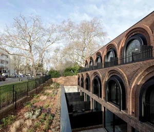 A modern building with arched windows and a brick facade.