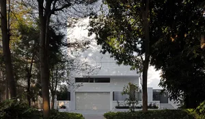 A modern residential house featuring concrete, glass, and steel materials.