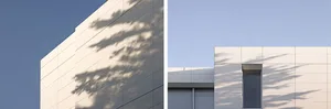 Modern building exterior featuring aluminum panels under clear blue sky.