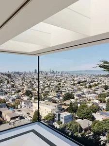 A glass window view of a modern cityscape on a clear day.