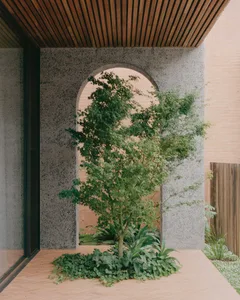 Concrete entrance with wooden frame and tree