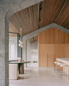 A modern kitchen featuring wooden beams on the ceiling and walls.