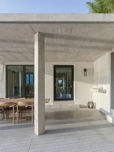 A modern terrace with concrete flooring and a view of the landscape.