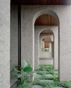 Architectural details of a modern building featuring concrete walls and arches.