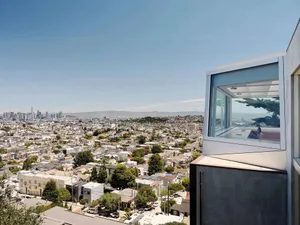 Modern glass window overlooking a sprawling urban cityscape.