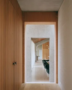 Modern entranceway featuring concrete walls and wooden elements.