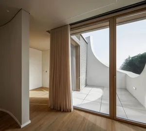 Modern interior design featuring a combination of wood, glass, and concrete materials.