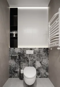 A modern bathroom featuring white and black marble walls and a sleek white toilet.