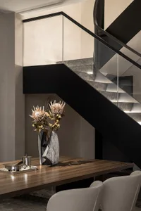 Modern staircase featuring a combination of stone and wood materials.