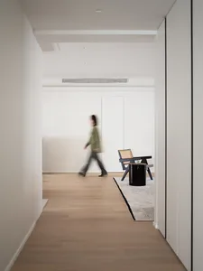 A minimalist interior design featuring wooden flooring and glass elements.