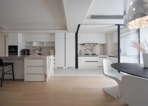 Modern white kitchen with marble countertops and white laminate cabinets