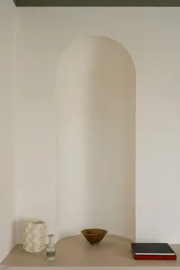 Modern shelf featuring ceramic vases and bowls.