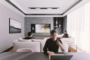 A modern living room featuring marble countertops and glass elements.